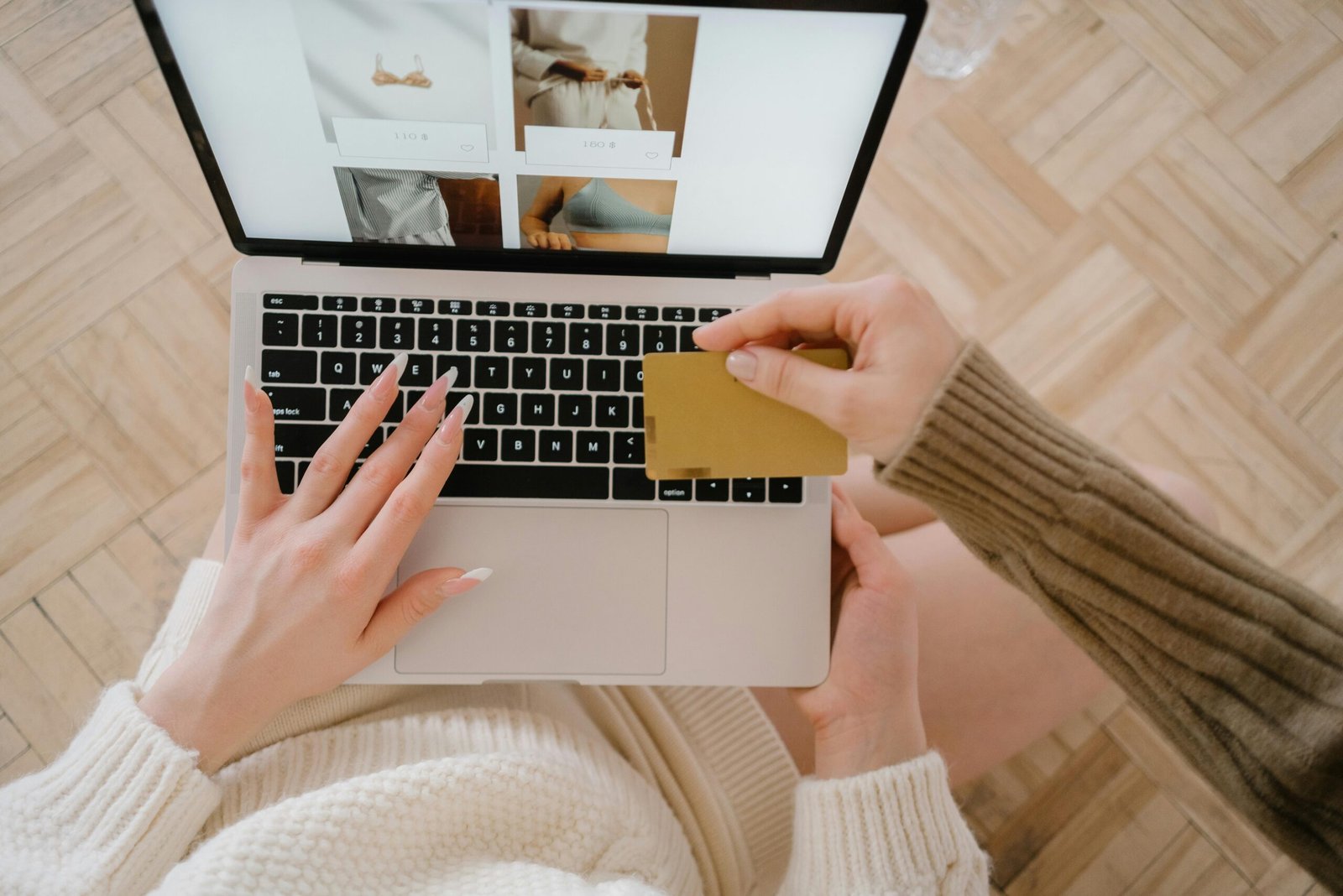 Person shopping online using a laptop and credit card, highlighting e-commerce convenience.